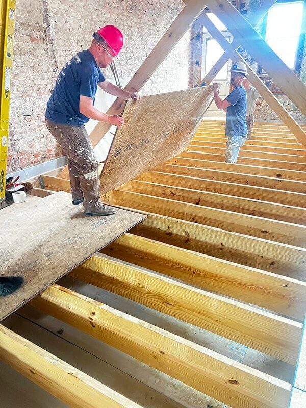 two people working on Habitat home construction