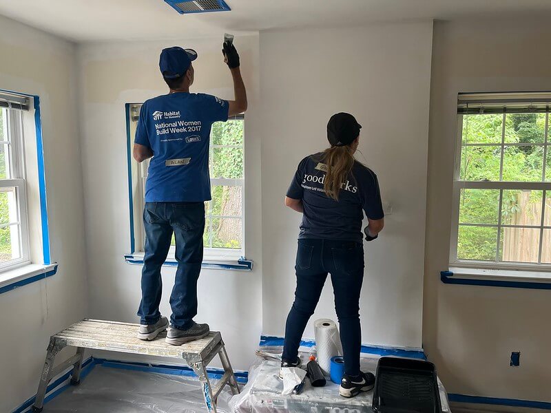 volunteers painting wall